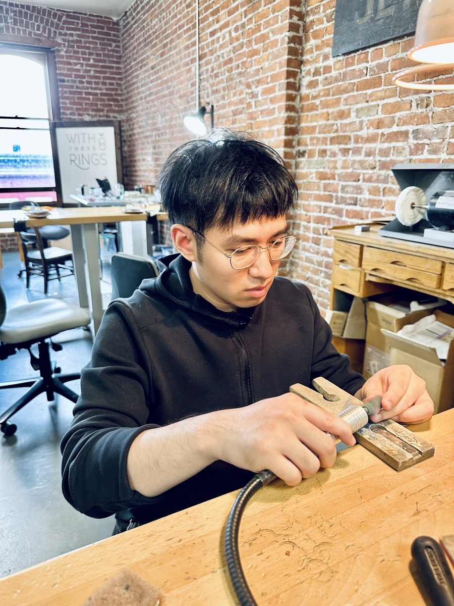 Hand-finishing a ring at a jewelry workbench