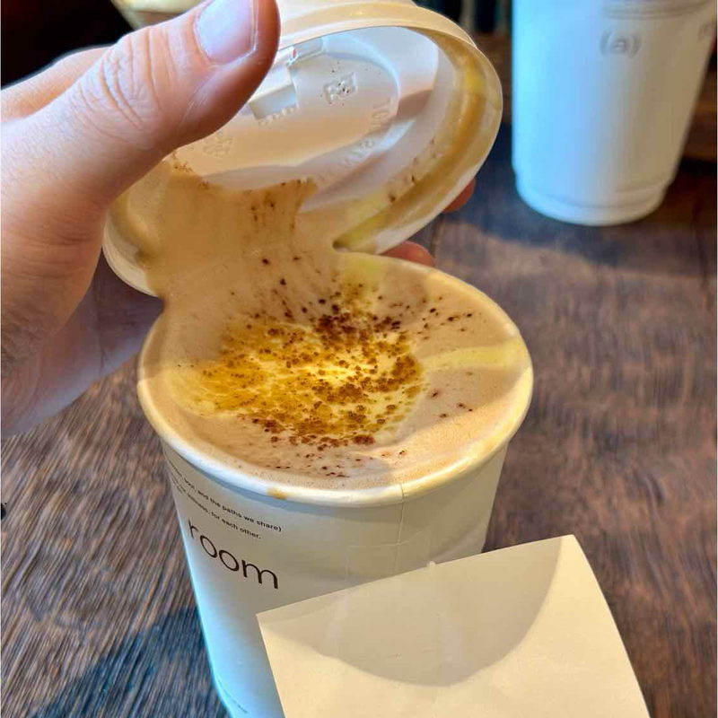 Egg coffee dusted with cinnamon, lid held open