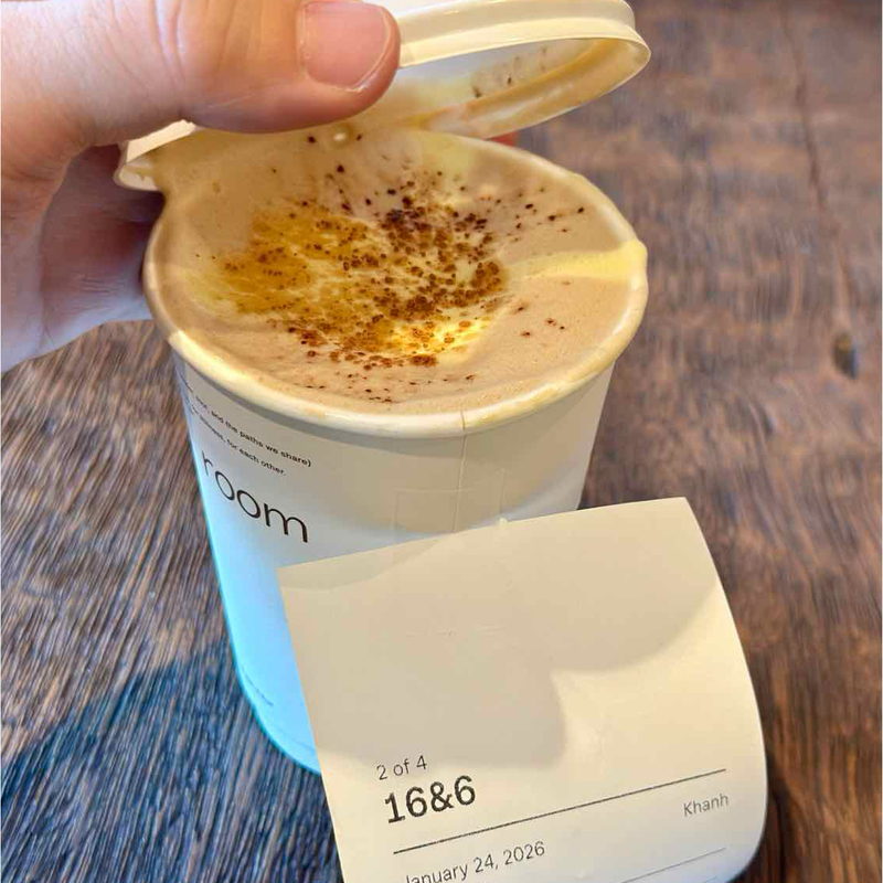 Egg coffee with the lid lifted, receipt in front